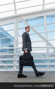 Businessman walking in urban environment of airport or office building