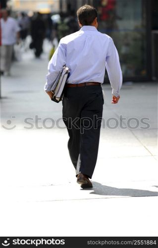 Businessman walking on a busy street downtown