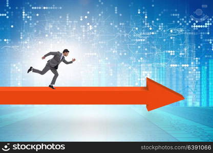 Businessman walking on arrow in business concept