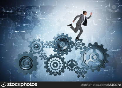 Businessman walking on cogwheels in teamwork concept