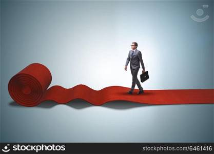Businessman walking on red carpet