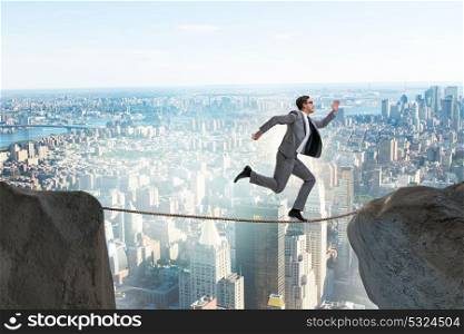 Businessman walking on tight rop in business concept