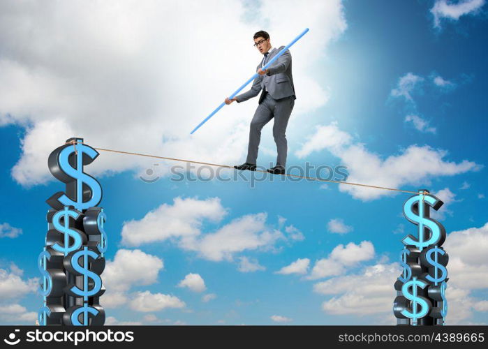 Businessman walking on tight rope