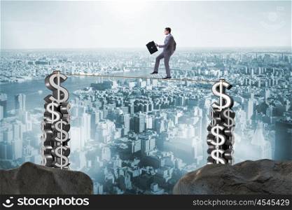 Businessman walking on tight rope