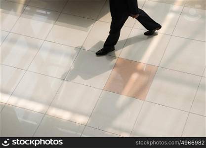 Businessman walking on tiled floor