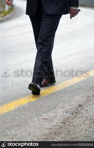 businessman walking on yellow line