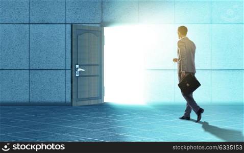 Businessman walking towards open door