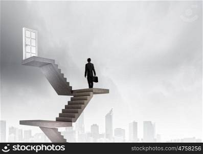 Businessman walking up staircase to door in sky. Way to success