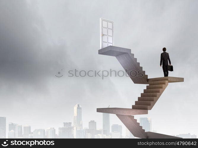 Businessman walking up staircase to door in sky. Way to success