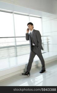 Businessman walking with mobile phone