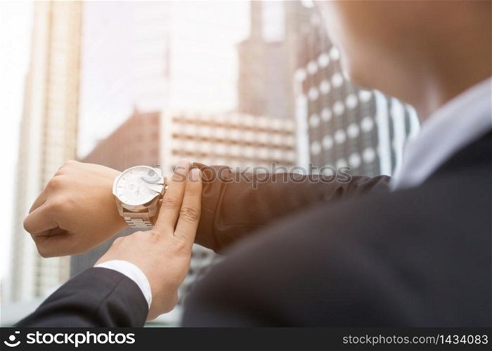 businessman was late for a meeting. He was watching his watch.