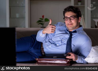 Businessman watching tv at night late