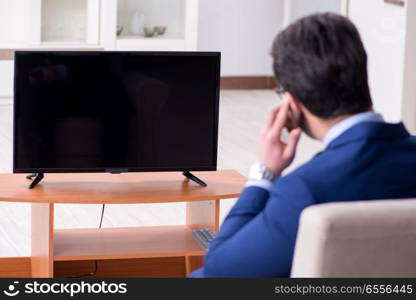 Businessman watching tv in the office