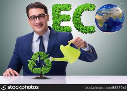 Businessman watering plan in recycling concept