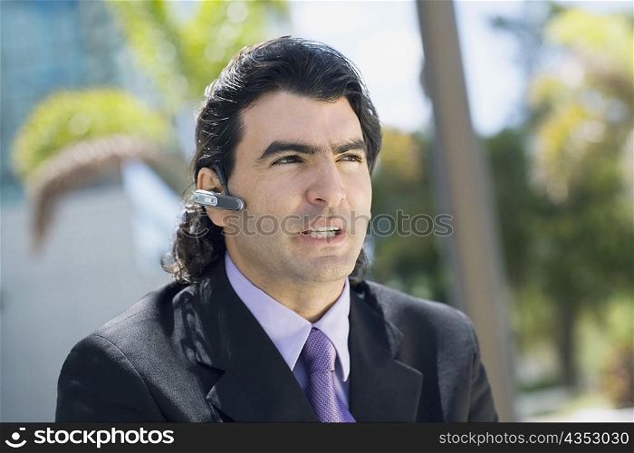 Businessman wearing a hands free device