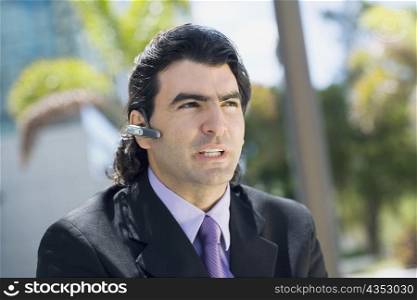 Businessman wearing a hands free device