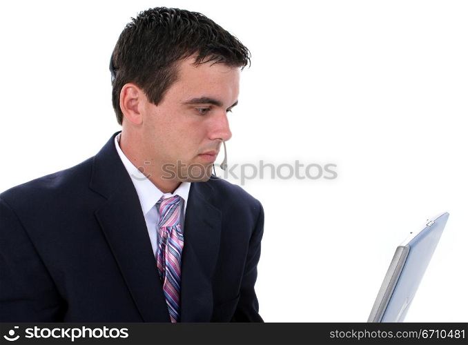 Businessman wearing a headset and working on a laptop
