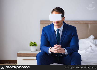 Businessman wearing a virtual reality headset in the bedroom