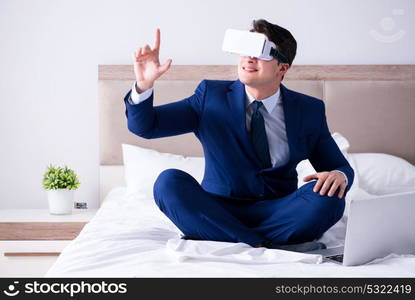 Businessman wearing a virtual reality headset in the bedroom