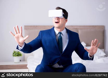 Businessman wearing a virtual reality headset in the bedroom