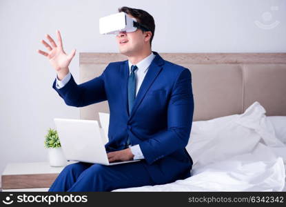 Businessman wearing a virtual reality headset in the bedroom