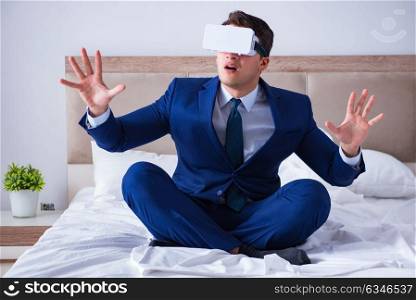 Businessman wearing a virtual reality headset in the bedroom