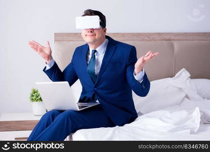 Businessman wearing a virtual reality headset in the bedroom