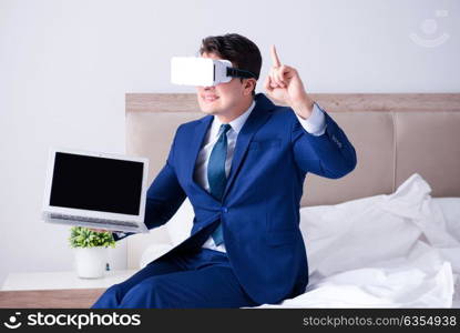 Businessman wearing a virtual reality headset in the bedroom