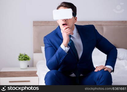 Businessman wearing a virtual reality headset in the bedroom