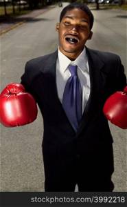Businessman wearing boxing gloves