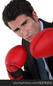 Businessman wearing boxing gloves