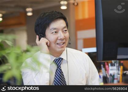 Businessman Wearing Headset in the Office