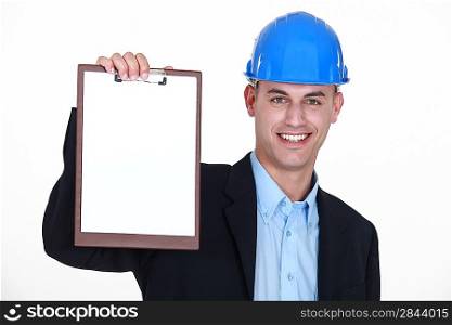 businessman wearing helmet and holding a notepad