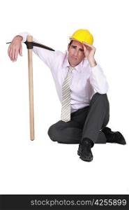 businessman wearing helmet and holding a pick