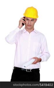 businessman wearing helmet and talking on the phone