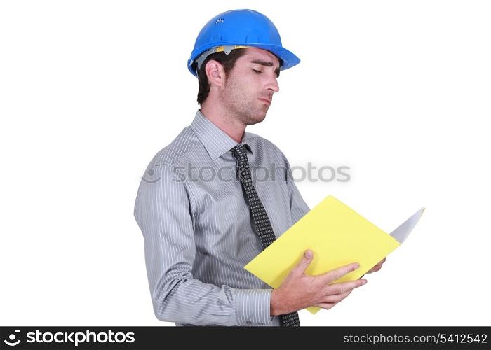 businessman wearing helmet taking notes