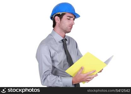businessman wearing helmet taking notes