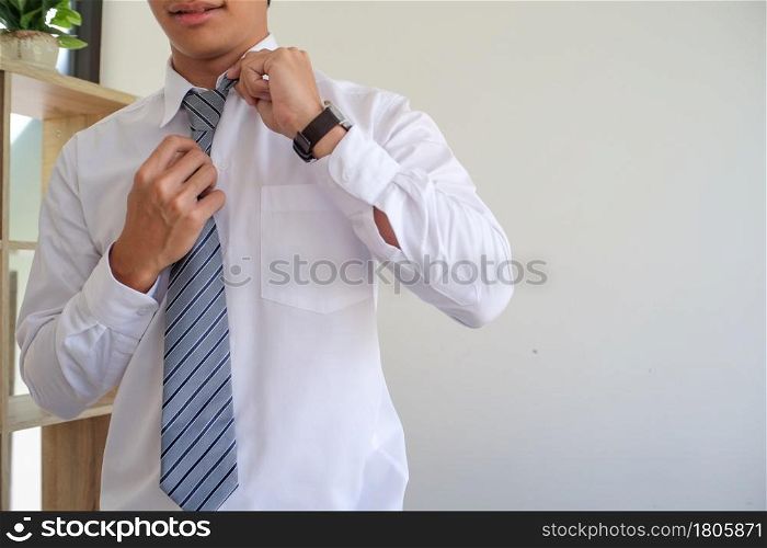 Businessman wearing tiepreparing for work in morning. Getting ready to go out. hastening to work
