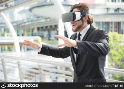 Businessman wearing virtual reality goggle glasses and enjoying in this activity, future technology concept, imagine concept