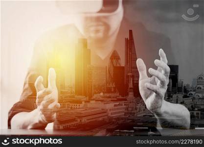 businessman wearing virtual reality goggles in modern office with mobile phone using with VR headset with London city exposure