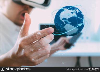 businessman wearing virtual reality goggles in modern office with mobile phone using with VR headset with world network diagram by NASA