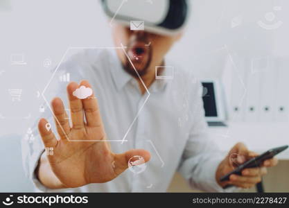 businessman wearing virtual reality goggles in modern office with mobile phone using with VR headset with screen icon diagram