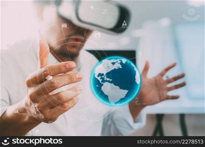 businessman wearing virtual reality goggles in modern office with mobile phone using with VR headset with world technology.element by NASA