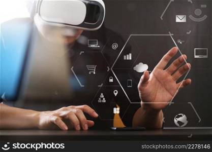 businessman wearing virtual reality goggles in modern office with Smartphone using with VR headset with screen icon diagram