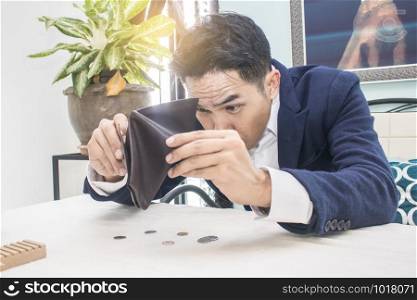 Businessman well-dressed with empty wallet-broke