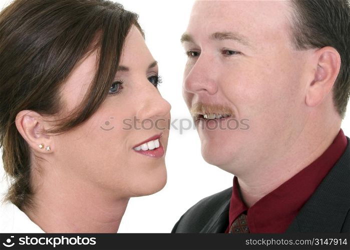 Businessman Whispering In Woman&acute;s Ear. Focus on Woman.