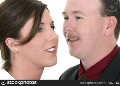 Businessman Whispering In Woman&acute;s Ear. Focus on Woman.