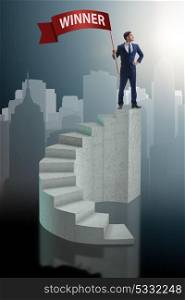 Businessman winner on top of staircase