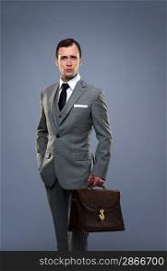 Businessman with a briefcase isolated on grey