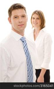 Businessman with a businesswoman standing behind him